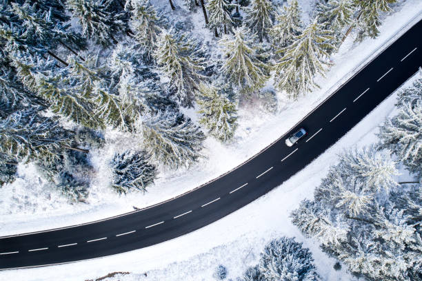 istock Road through the wintery forest - aerial view 1097603068