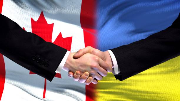 istock Canada and Ukraine handshake international friendship relations, flag background 1097603094