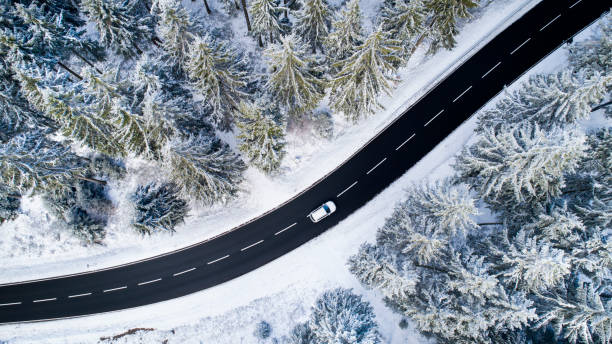 istock Road through the wintery forest - aerial view 1097603132