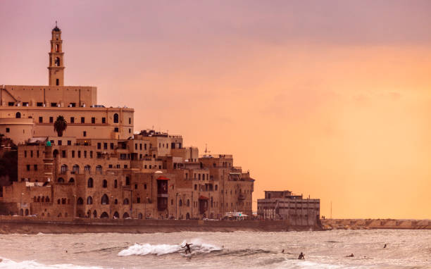 istock Jaffa sunset, surfers in action - Tel Aviv, Israel 1097605268