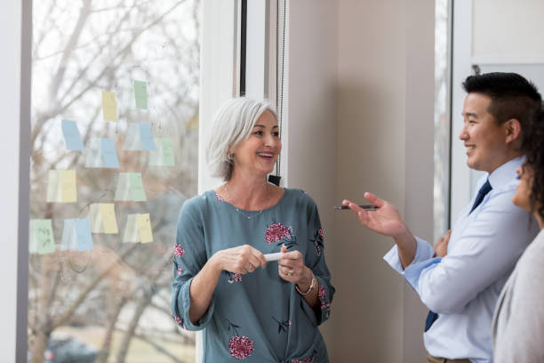 istock Business manager enjoys brainstorming with employees 1097606038