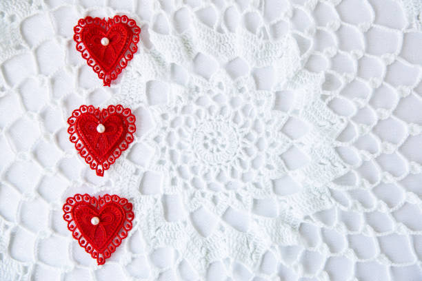 istock red lace hearts placed on side of white lace background 1097627054