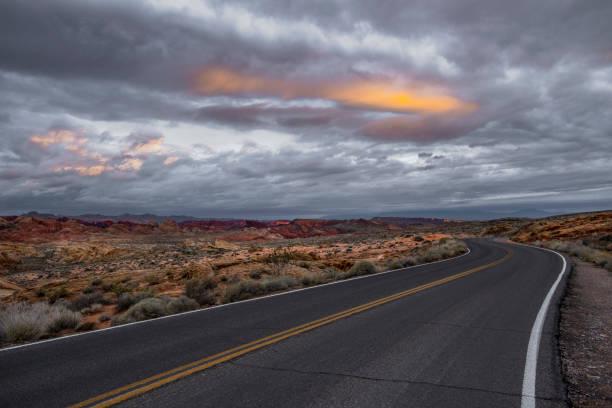 istock Dramatic sunrise over desert landscape with empty road 1097627138