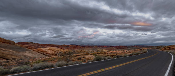 istock Dramatic sunrise over desert landscape with empty road 1097627146