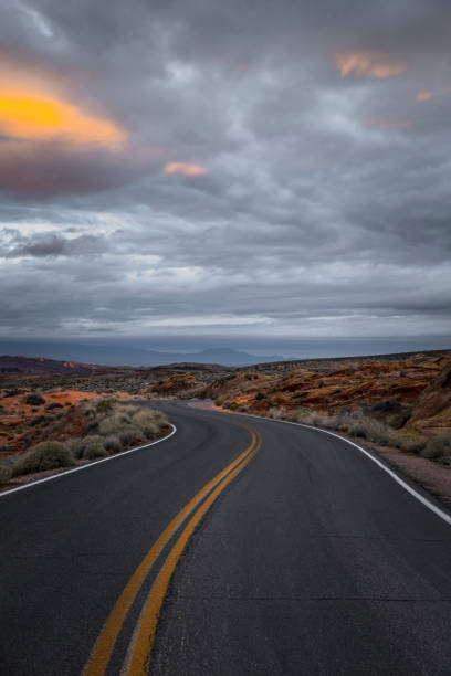 istock Dramatic sunrise over desert landscape with empty road 1097627160