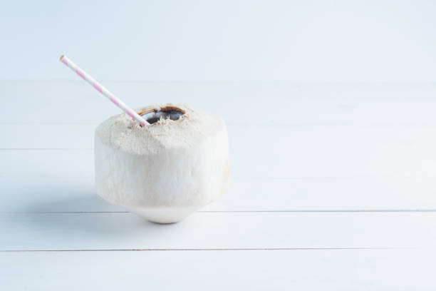 istock Coconut with a straw isolated on white background. 1097630660