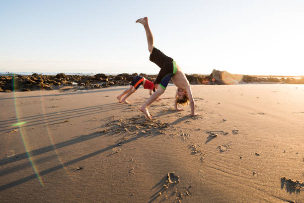 istock Yoga on the beach with young children 1097631166