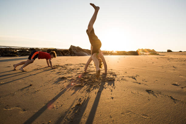 istock Children doing yoga on the beach in Santa Barbara 1097631190