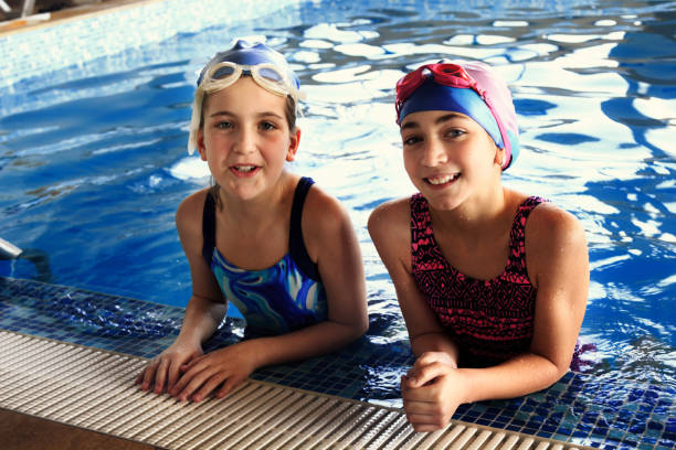 istock Two girls in a swimming pool 1097631254