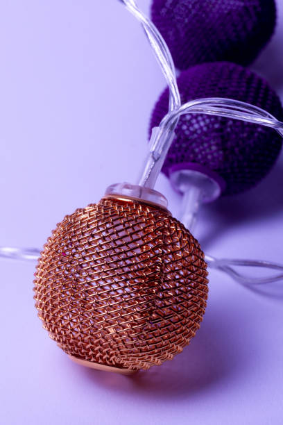 istock Battery garland with metallic grid balls on white background. Closeup view with blurred background. 1097631698