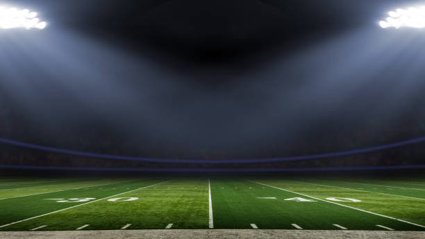Football stadium American football field illuminated by stadium lights american football field photos stock pictures, royalty-free photos & images