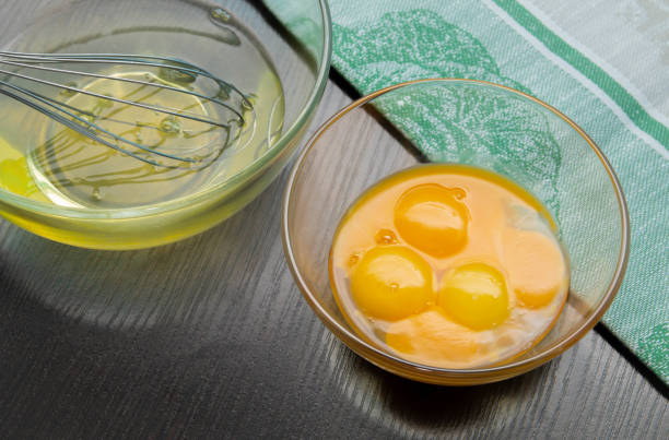 istock egg whites and yolks in transparent glass cups with a whisk 1097633598
