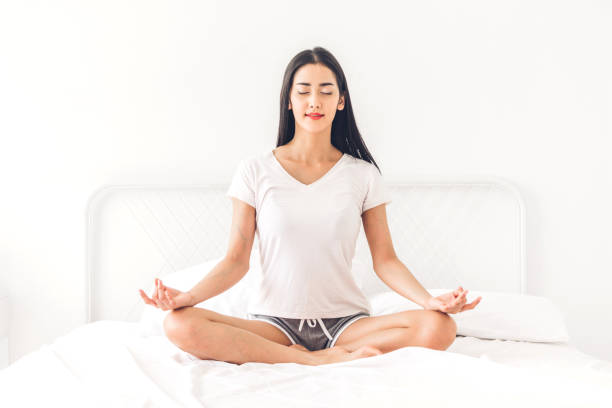 istock Woman practicing yoga at home in bedroom 1097634378