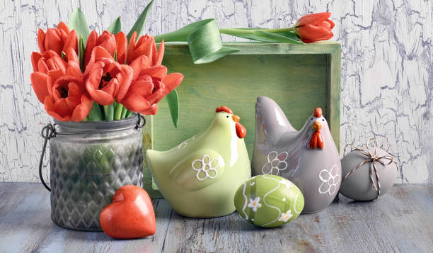 istock Easter composition with red tulips, ceramic hens and Easter eggs on light wood 1097637812