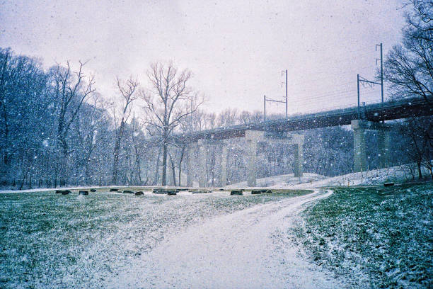 Snow falls in a field before a bridge Philadelphia, PA philadelphia winter stock pictures, royalty-free photos & images