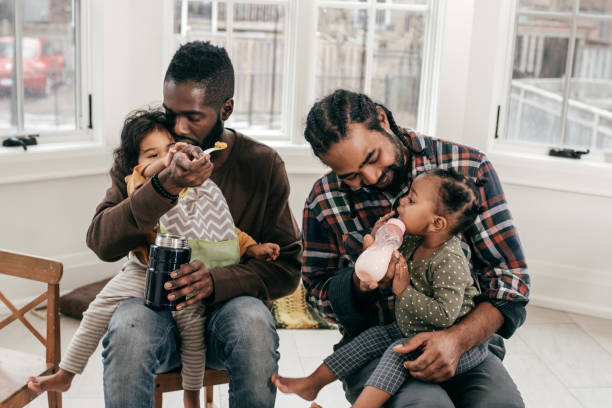 istock Lunch time and two dads with two toddlers 1097642578