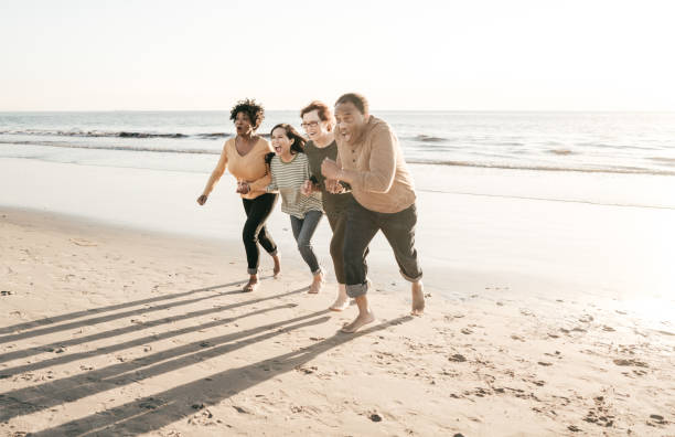 istock Senior friends having fun on the beach 1097644656