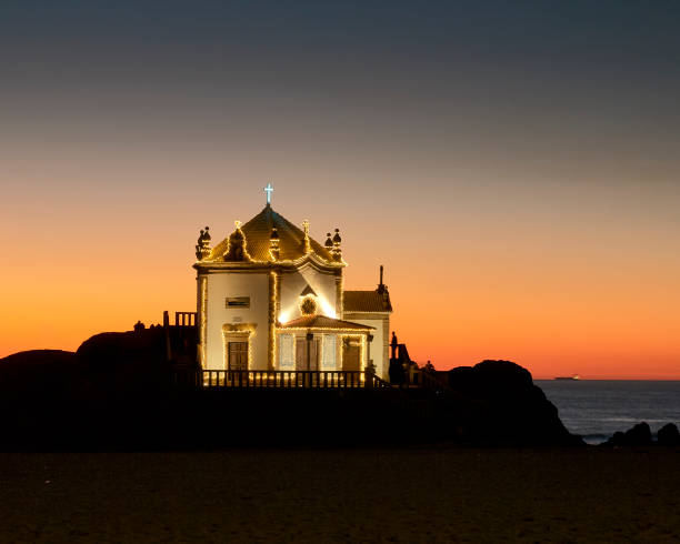 istock sunset behind church of Sr. da Pedra 1097648152