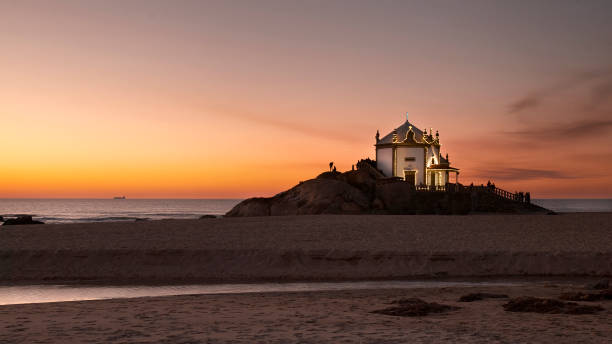 istock light clouds over the beach church at sunset 1097648210