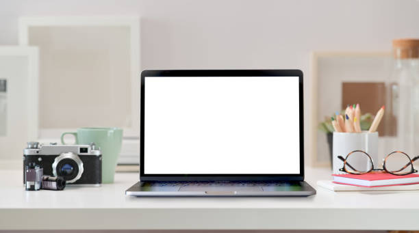 istock Loft workspace with blank screen laptop, vintage camera and home office supplies 1097656836