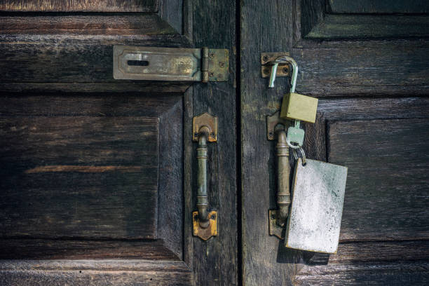 istock Old rusty and key locks on wooden door 1097659036