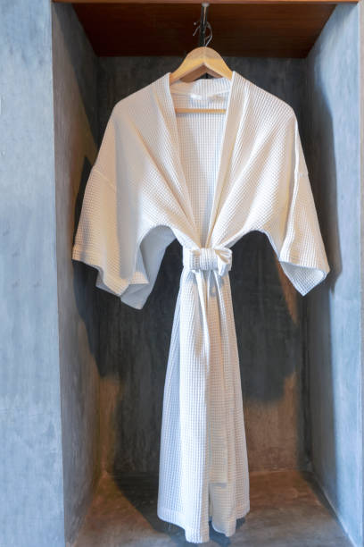 istock White robe in the Closet with cement background 1097660104