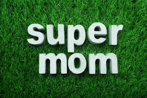 istock Super Mom made from concrete alphabet top view on green grass 1097670594