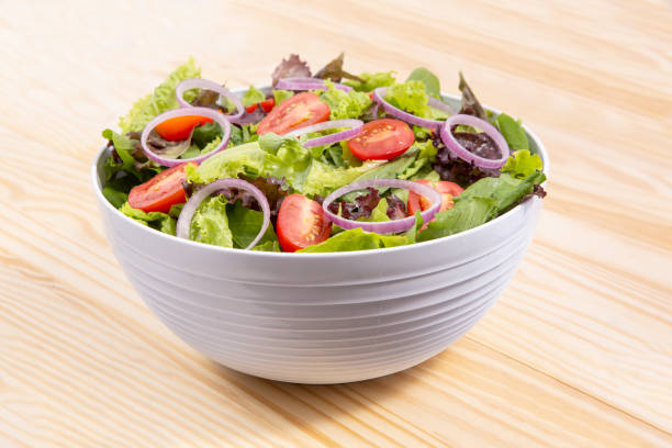 fresh vegetables salad with cabbage, onion and tomato in bowl color fresh vegetables salad with cabbage, onion and tomato in bowl color salad bowl stock pictures, royalty-free photos & images