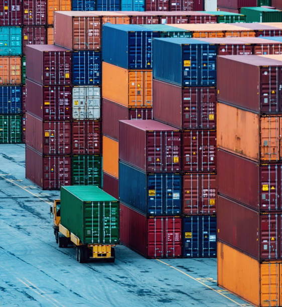 Container Pier Shipping containers stacked high at a container pier. cargo container stock pictures, royalty-free photos & images