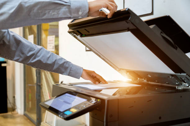istock Business man Hand press button on panel of printer, printer scanner laser office copy machine supplies start 1097676990