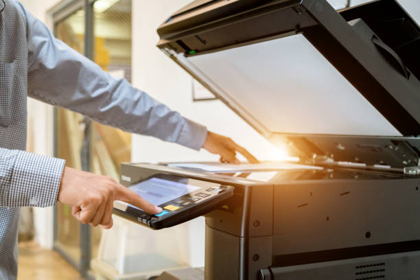 istock Business man Hand press button on panel of printer, printer scanner laser office copy machine supplies start 1097677008