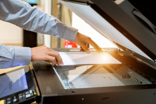 istock Business man Hand press button on panel of printer, printer scanner laser office copy machine supplies start 1097677028