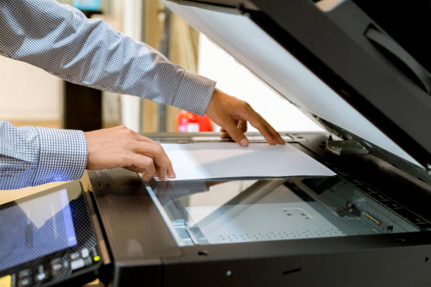 istock Business man Hand press button on panel of printer, printer scanner laser office copy machine supplies start 1097677032