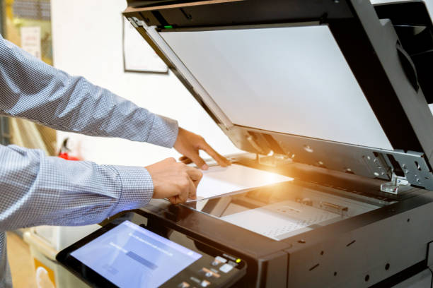 istock Business man Hand press button on panel of printer, printer scanner laser office copy machine supplies start 1097677096