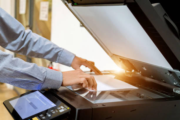 istock Business man Hand press button on panel of printer, printer scanner laser office copy machine supplies start 1097677118