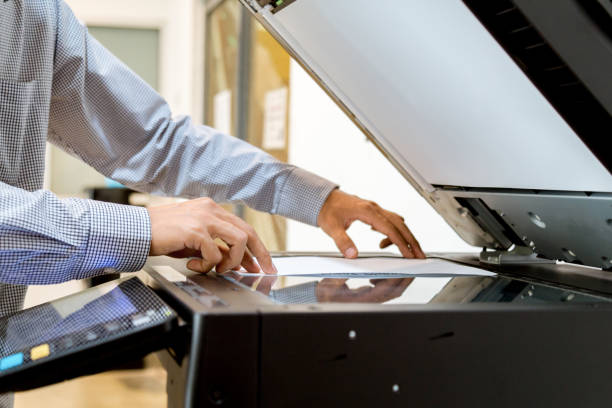 istock Business man Hand press button on panel of printer, printer scanner laser office copy machine supplies start 1097677146