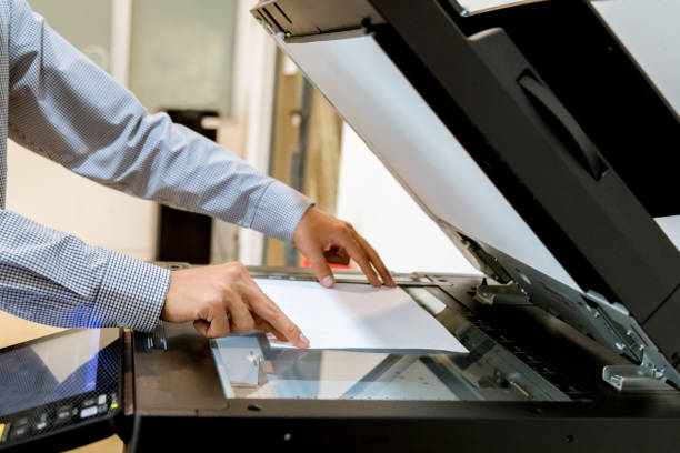 istock Business man Hand press button on panel of printer, printer scanner laser office copy machine supplies start 1097677148