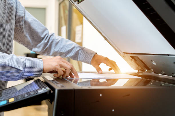 istock Business man Hand press button on panel of printer, printer scanner laser office copy machine supplies start 1097678192