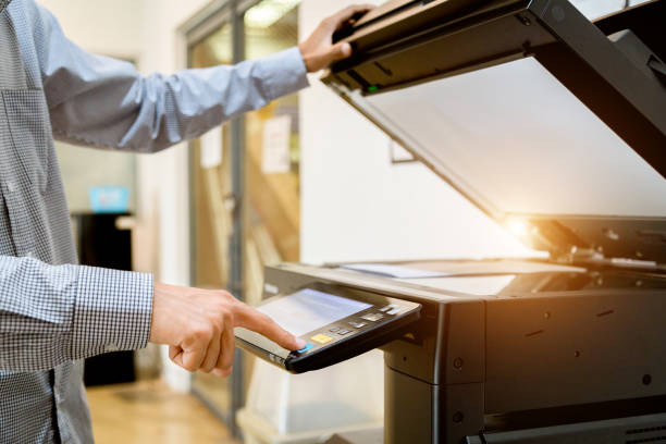 istock Business man Hand press button on panel of printer, printer scanner laser office copy machine supplies start 1097678194