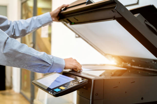 istock Business man Hand press button on panel of printer, printer scanner laser office copy machine supplies start 1097678196