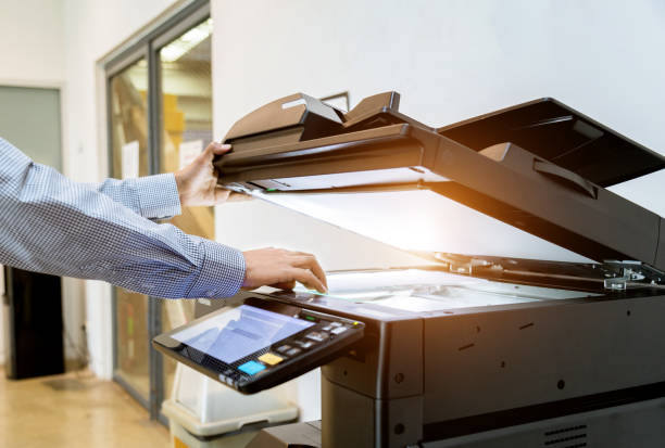 istock Business man Hand press button on panel of printer, printer scanner laser office copy machine supplies start 1097678258