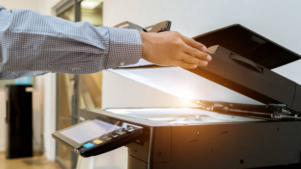 istock Business man Hand press button on panel of printer, printer scanner laser office copy machine supplies start 1097678346