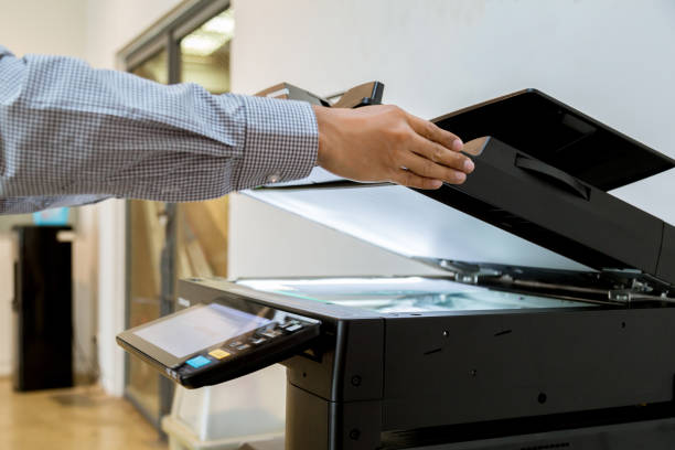 istock Business man Hand press button on panel of printer, printer scanner laser office copy machine supplies start 1097678348