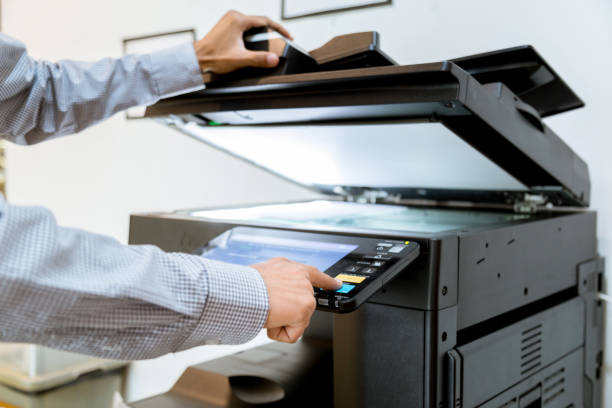istock Business man Hand press button on panel of printer, printer scanner laser office copy machine supplies start 1097678352