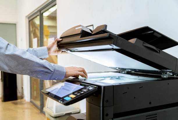 istock Business man Hand press button on panel of printer, printer scanner laser office copy machine supplies start 1097678364
