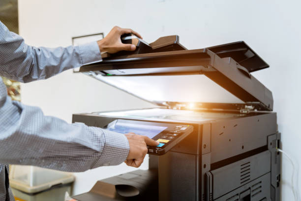 istock Business man Hand press button on panel of printer, printer scanner laser office copy machine supplies start 1097678370