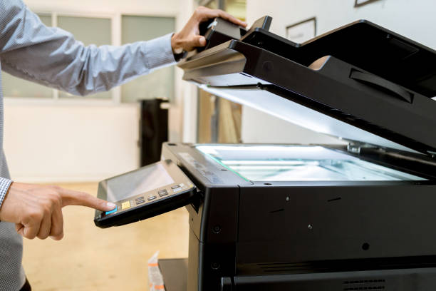 istock Business man Hand press button on panel of printer, printer scanner laser office copy machine supplies start 1097678420