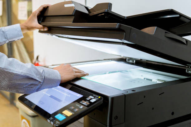 istock Business man Hand press button on panel of printer, printer scanner laser office copy machine supplies start 1097678546