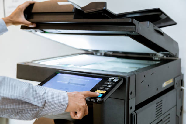 istock Business man Hand press button on panel of printer, printer scanner laser office copy machine supplies start 1097678566