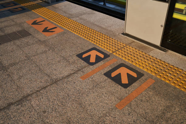 istock Yellow Arrow Sign on Platform Floor 1097680022